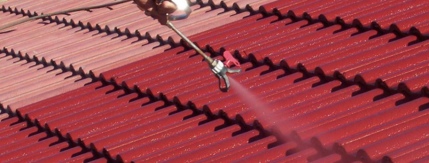 man painting and cleaning roof in Langley